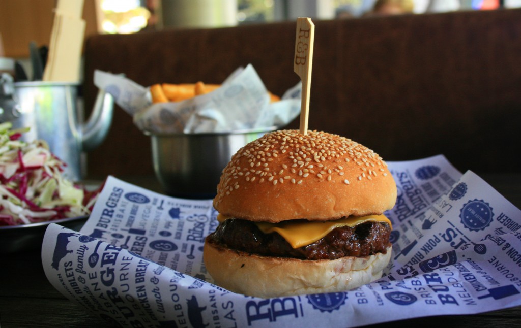 Old School Cheeseburger: a dense beef patty; cheese; onion; tomato; mustard; aioli; and pickles.